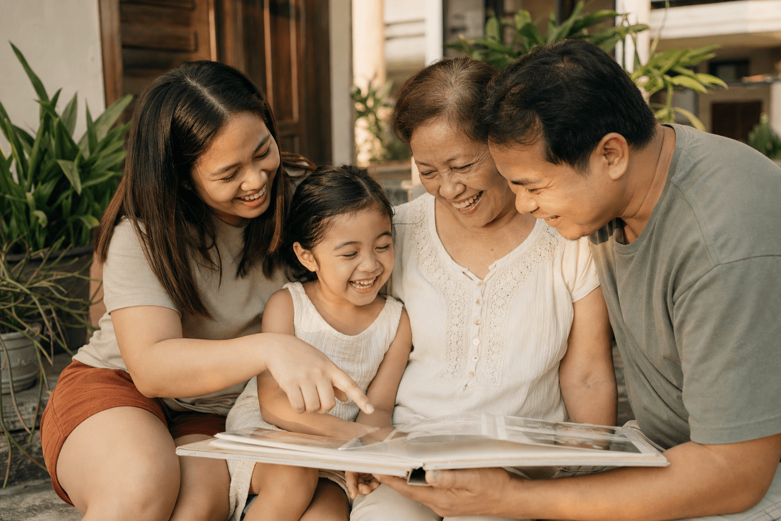 A happy multi-generational Filipino family together at home, representing the Family Insurance Plan